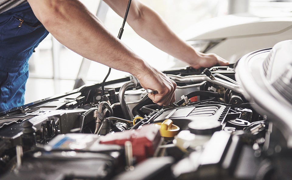A technician servicing engine oil